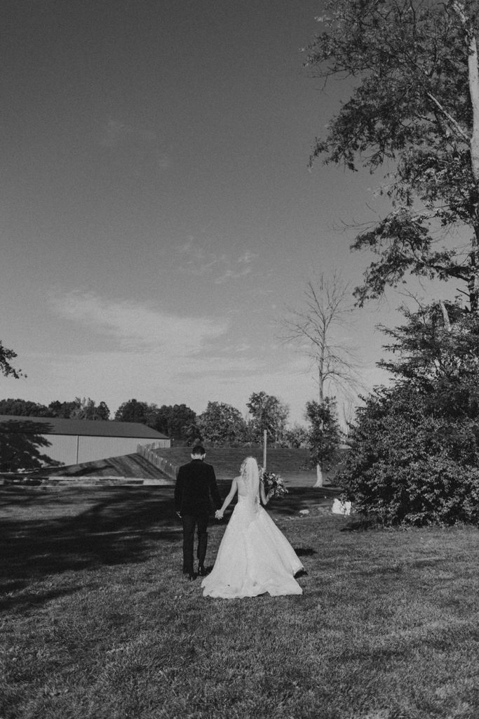 bride and groom walking away 