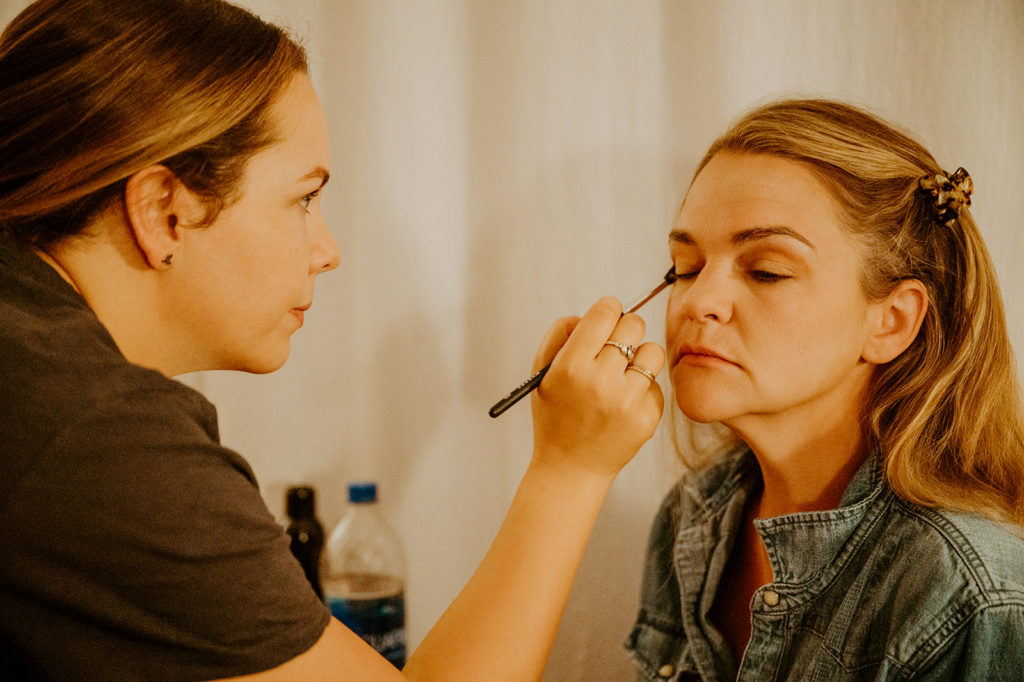Bride getting ready with makeup for elopement