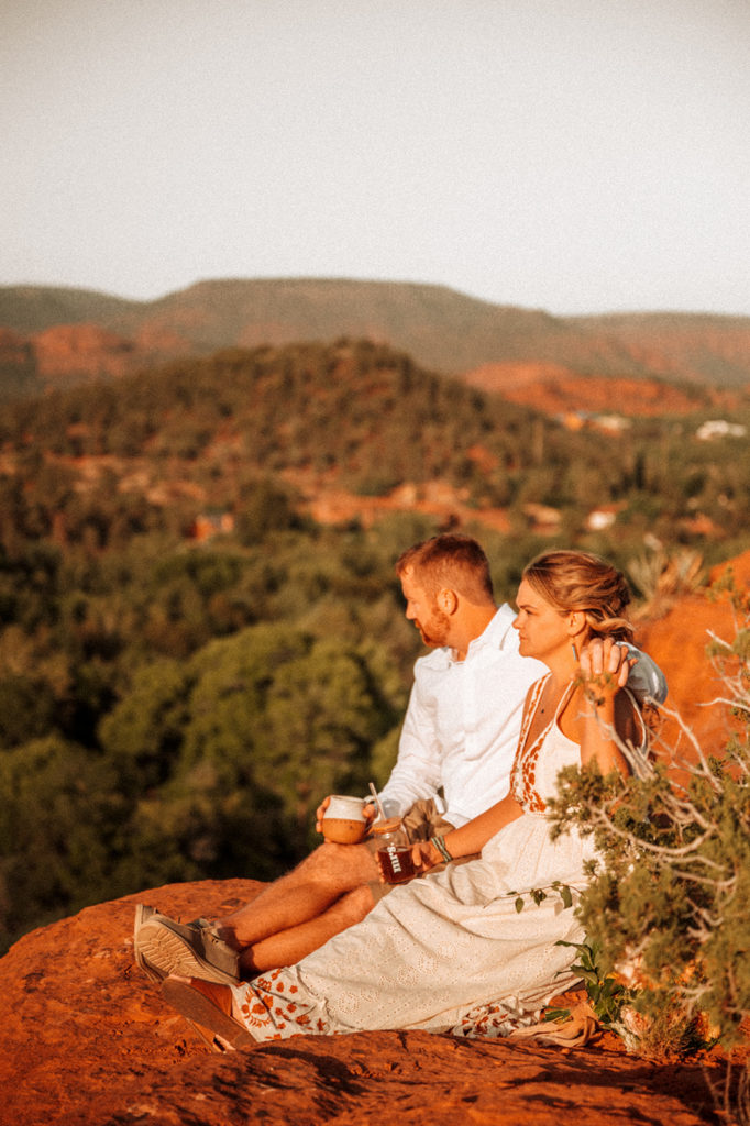 Couple sitting on mountain during elopement in Arizona
