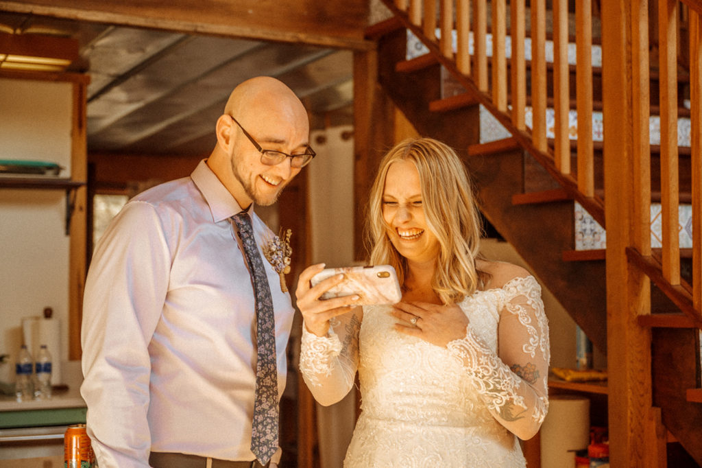 Bride and groom facetiming family and friends after elopement