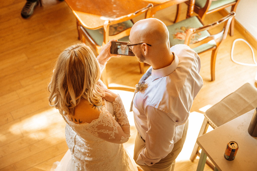 Bride and groom facetiming family and friends after elopement