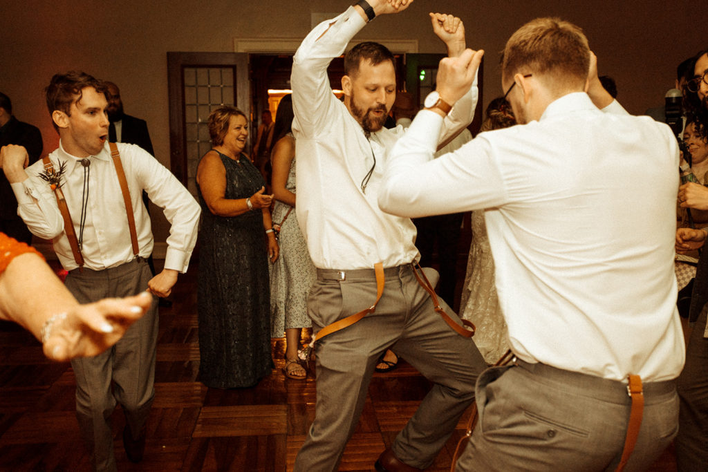 wedding guests dancing during wedding reception